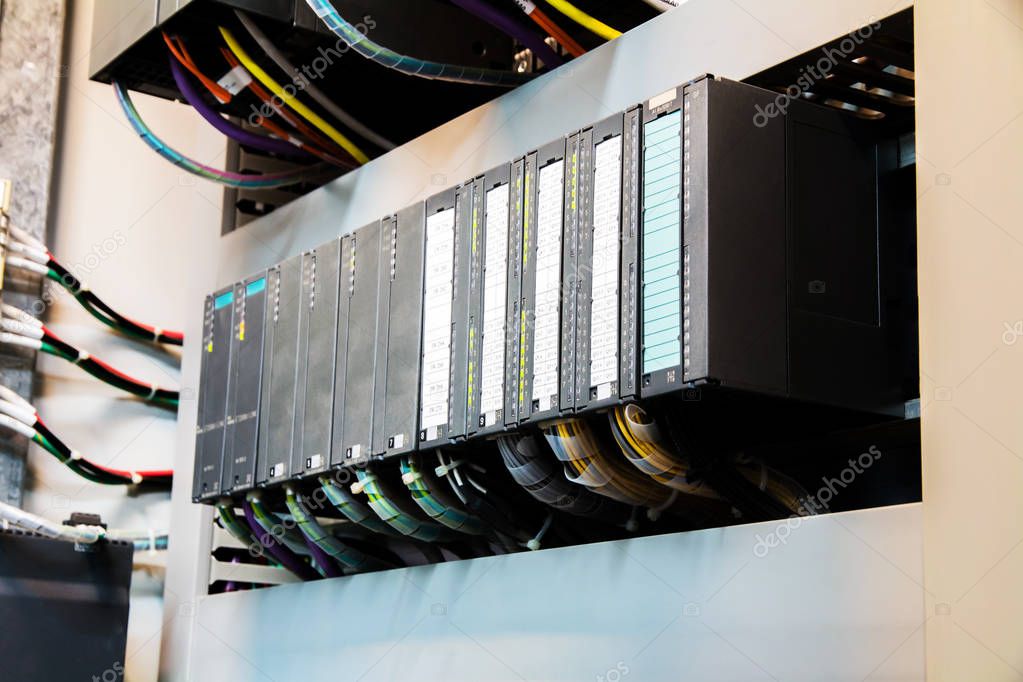 Engineer configuring PLC and HMI panel