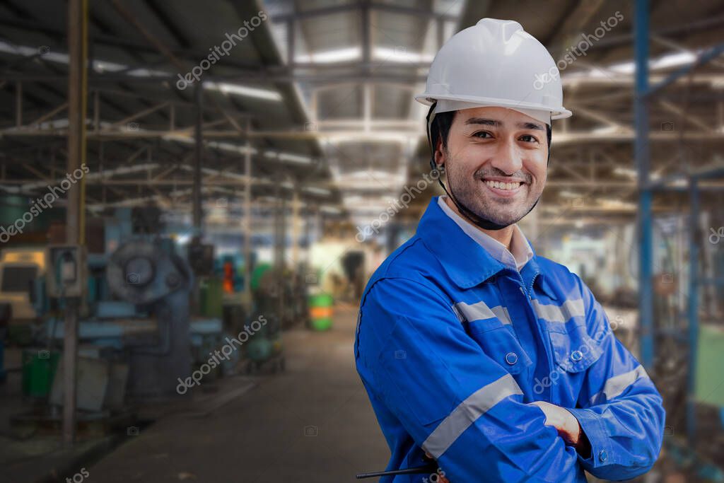 Engineer updating automation documentation near industrial equipment