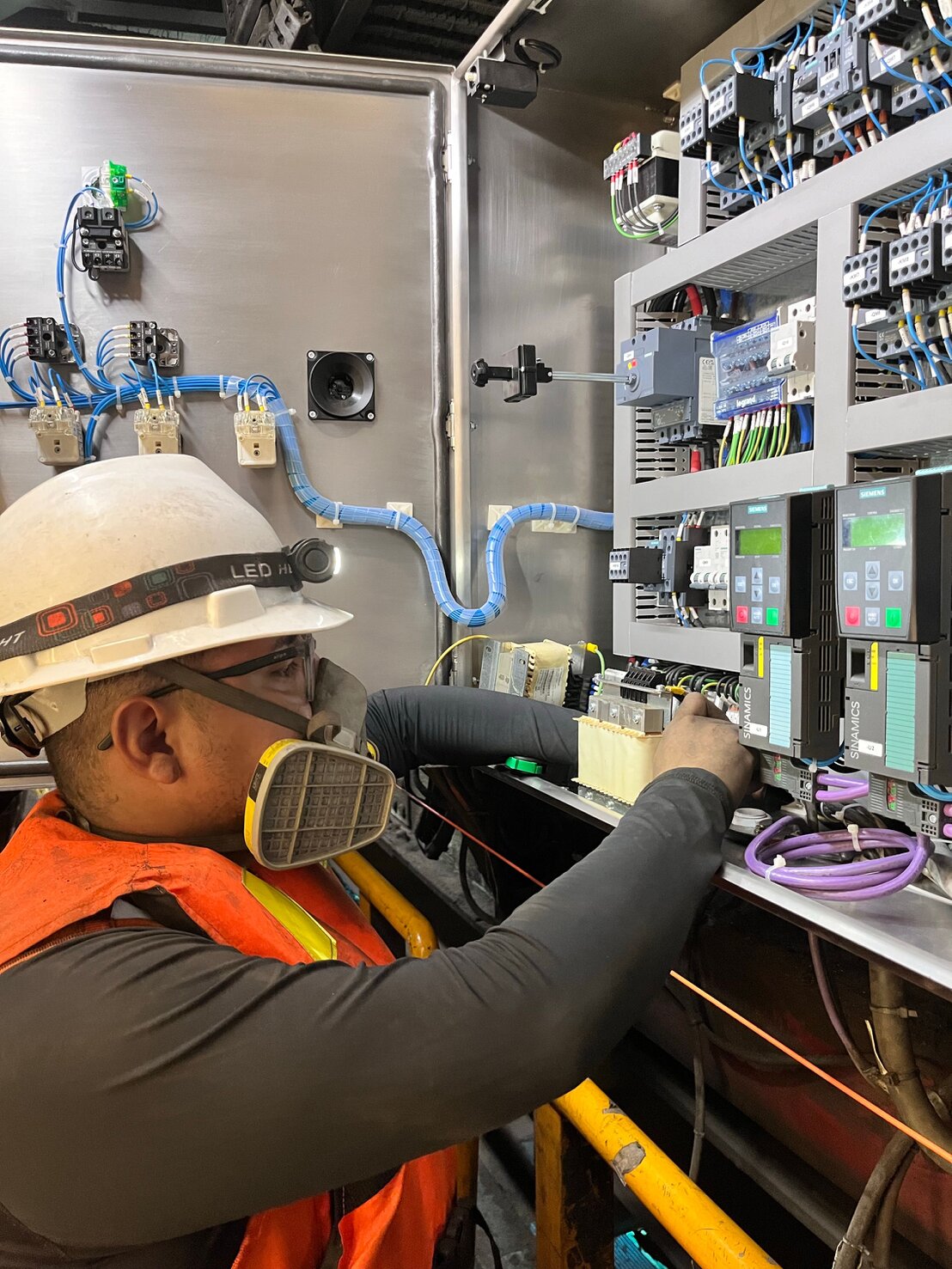 Engineer configuring PLC and HMI panel