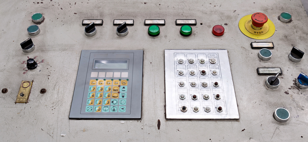 Engineer working on PLC and HMI screen in an industrial environment